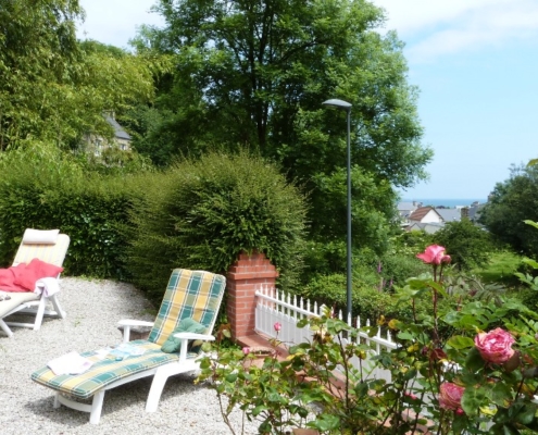 La terrasse du gite l'avenue avec la table du déjeuner, vue sur le mer de la manche et les bains de soleil